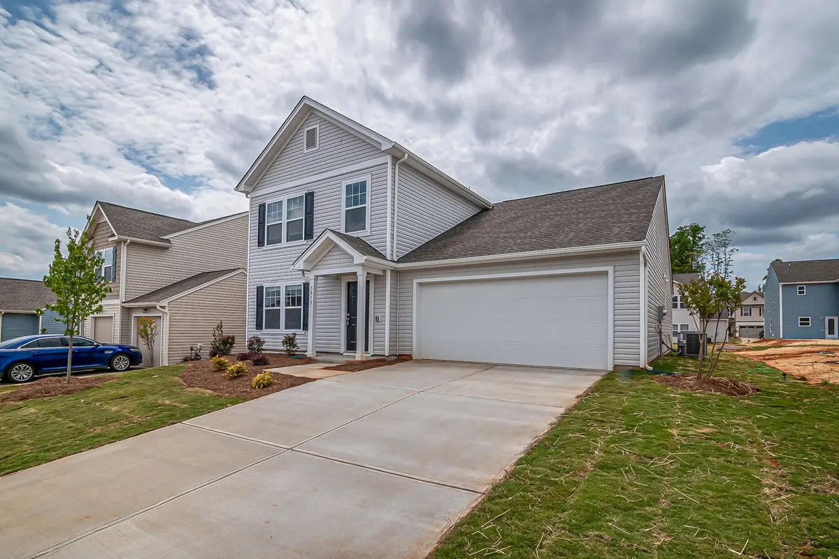 A two-car garage door and driveway on the front elevation of a suburban home